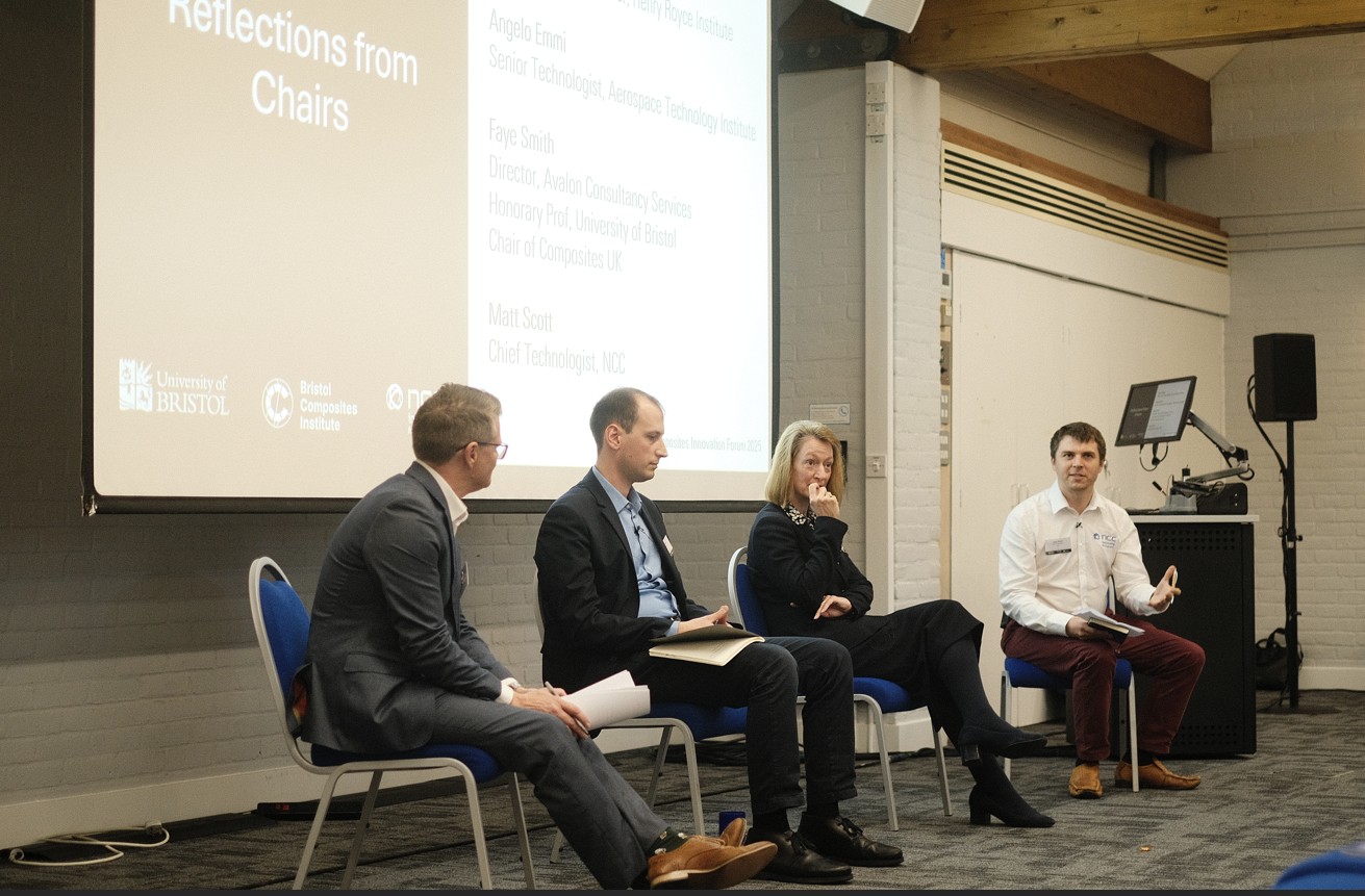 Four people sat in front of a large screen